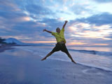 Happy and healthy boy jumping at the beach